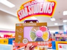 hand holding a gobo spinner lunchbox in front of target signage