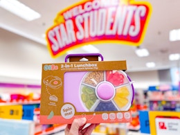 hand holding a gobo spinner lunchbox in front of target signage