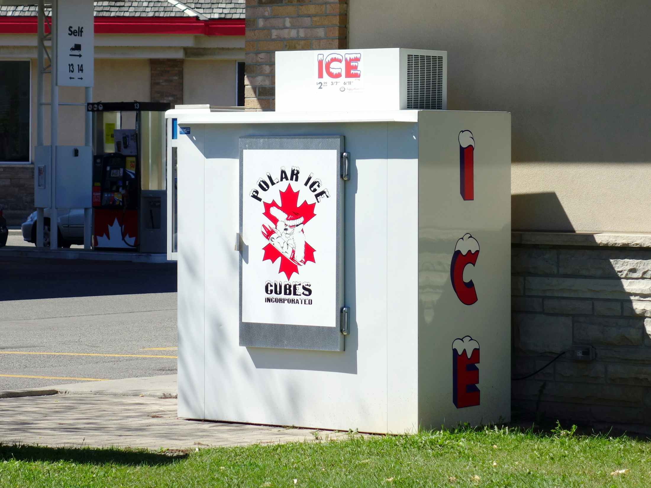An ice machine located outside of a gas station
