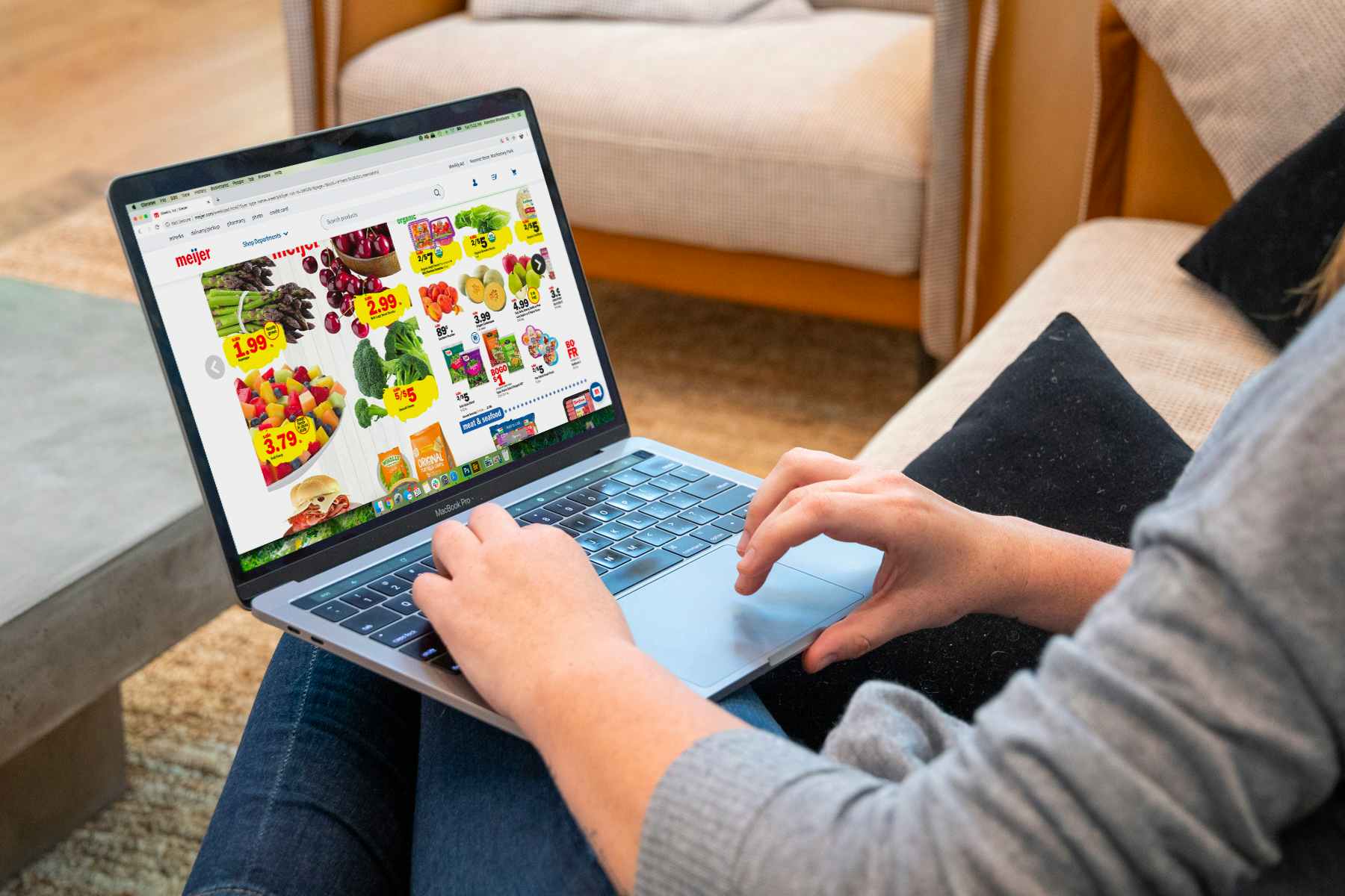 Woman on laptop looking at the Meijer website 