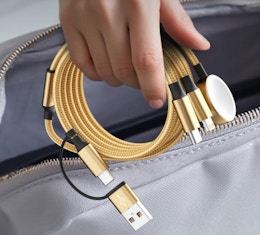 a hand holding a charging cord