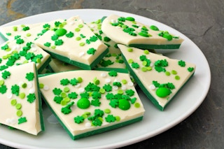 Chocolate bark decorated with green and shamrock candies
