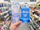 hand holding crest pen and whitening kit in walgreens