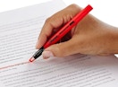 a hand highlighting words on a page