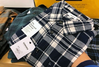 someone holding a flannel shirt