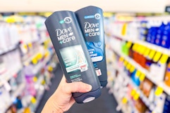 hand holding two Dove Men+Care body washes