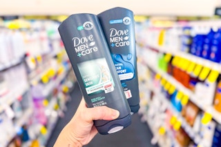 hand holding two Dove Men+Care body washes