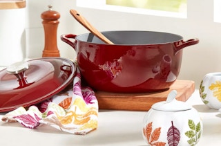 a red cast iron dutch oven on a table