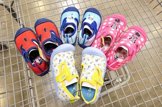 four pairs of kids character water shoes in a cart