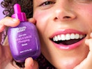 a person hold a bottle of purple face serum 