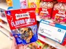 hand holding a milk-bone dog treat in front of target signage