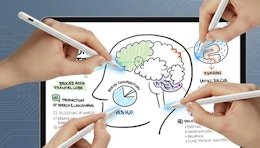 hands writing on an iPad with pencils 