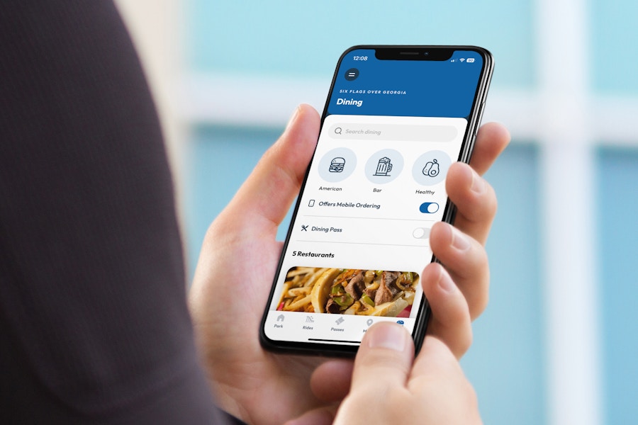 someone looking at food to order on the six flags app