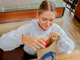 a person taking nuggets out of a wendys bag