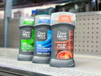 3 dove men+care deodorants sitting on a Walmart shelf