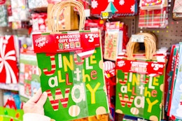 hand holding holiday gift bags