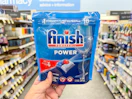 hand holding finish dishwasher tabs in walgreens
