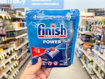 hand holding finish dishwasher tabs in walgreens