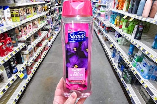 hand holding a bottle of suave essentials body wash at dollar general