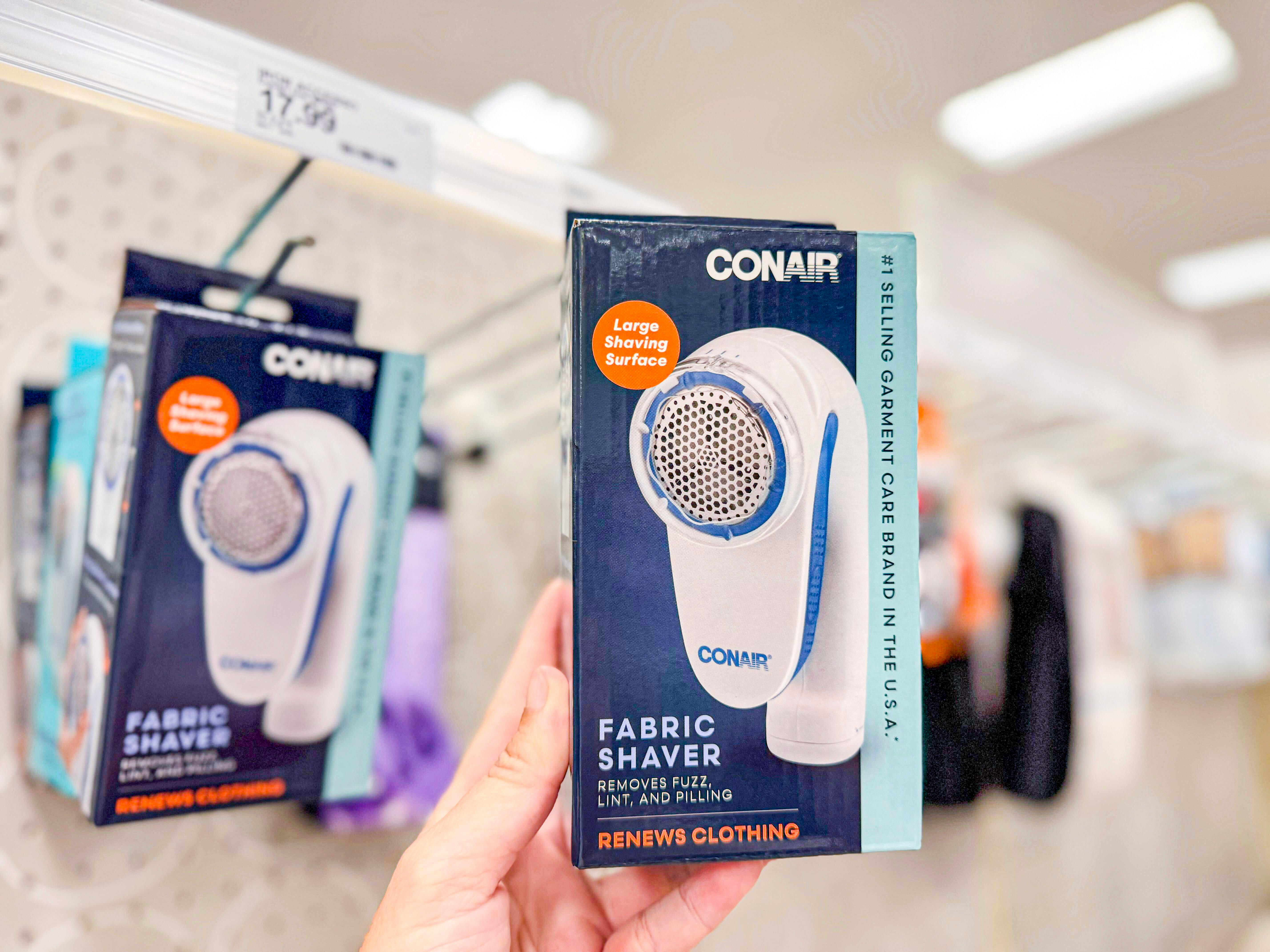 hand holding a conair fabric shaver at Target