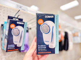 hand holding a conair fabric shaver at Target