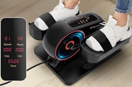 Person using the ANCHEER Under Desk Elliptical Machine on the floor.