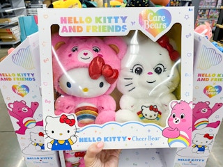 hand holding hello kitty care bears set at walmart