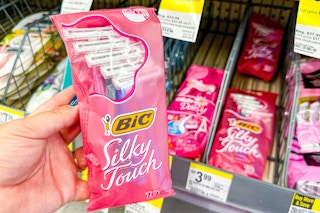 hand holding a pack of bic silky touch razors
