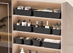 drawer organizers full of beauty items in a cabinet