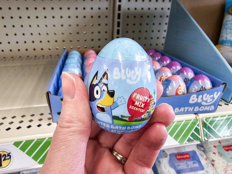 person holding a bluey bath bomb in front of more bath bombs