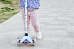 Child riding a bluey light up scooter