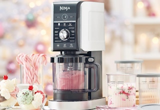 view of ninja frozen treat maker on kitchen counter surrounded by treats