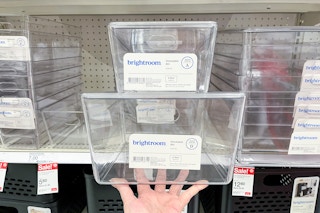 hand holding 2 brightroom stacking lidded bins in front of a target shelf