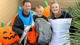 a family in front of a house in a halloween rock paper scissor costume
