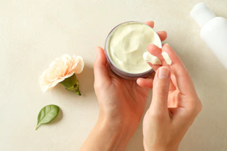 a woman using beef tallow cream