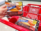 hand holding one Ball Park Franks pack next to another in shopping cart