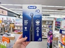 hand holding oral-b electric toothbrush in walgreens