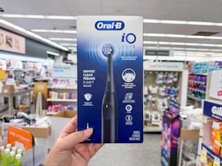 hand holding oral-b electric toothbrush in walgreens