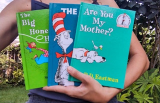 a women holding three dr. seuss books