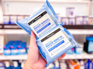 hand holding 2 packs of neutrogena wipes at target