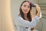 a woman using a hair straightener