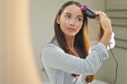 a woman using a hair straightener