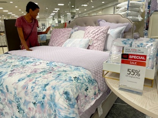 person standing by a bed