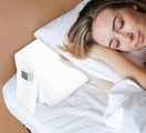 a person laying on a pillow and wedge pillow 