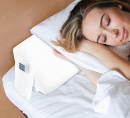 a person laying on a pillow and wedge pillow 