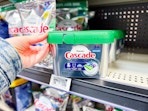 hand holding cascade pods on walmart shelf