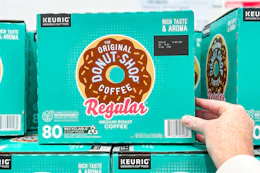 hand touching a box of donut shop k-cups