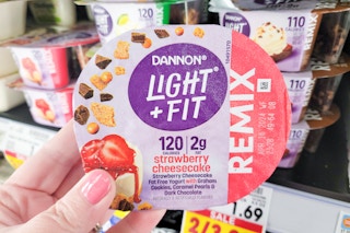 hand holding dannon remix yogurt at kroger