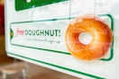 a sign for a free donut at Krispy Kreme