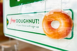 a sign for a free donut at Krispy Kreme